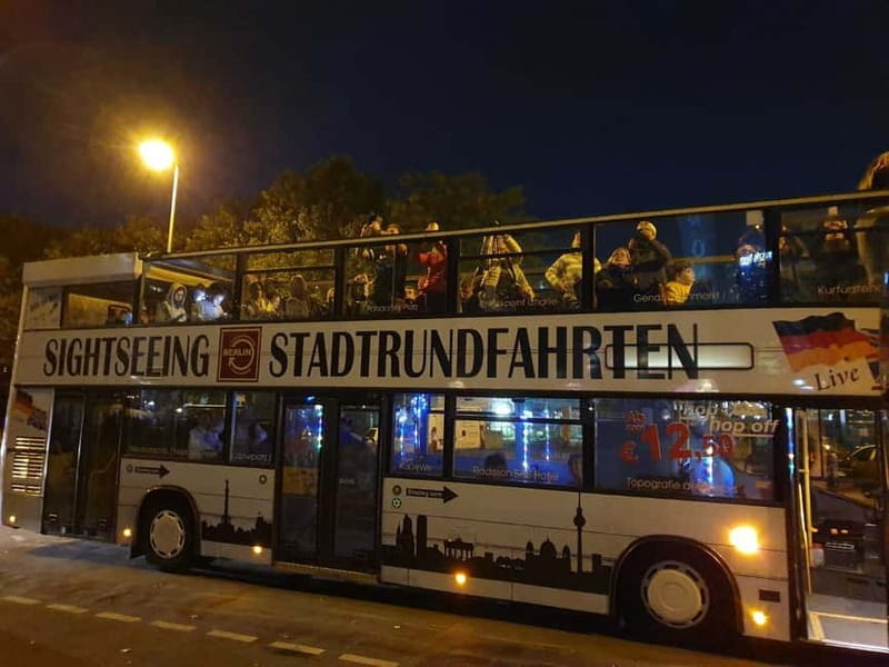 Berlin: Bus Tour by Night with Live Commentary - Open-top seating, cold weather, and photo stops