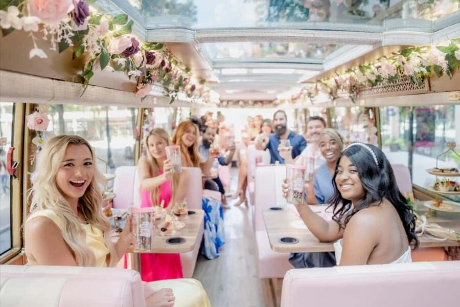 Dallas: Tea Around Town Bus Tour with Treats - A pink bus with a proper tea service