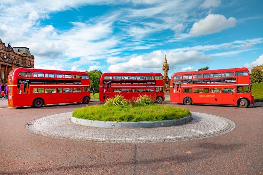 Edinburgh: Vintage Bus Tour with Afternoon Tea or Gin - A vintage bus, a full tea tray, and Edinburgh outside