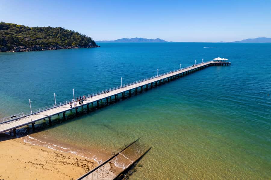 Magnetic Island: Guided Bus Tour with Morning Tea - Cockle Bay and Picnic Bay show two sides of the island
