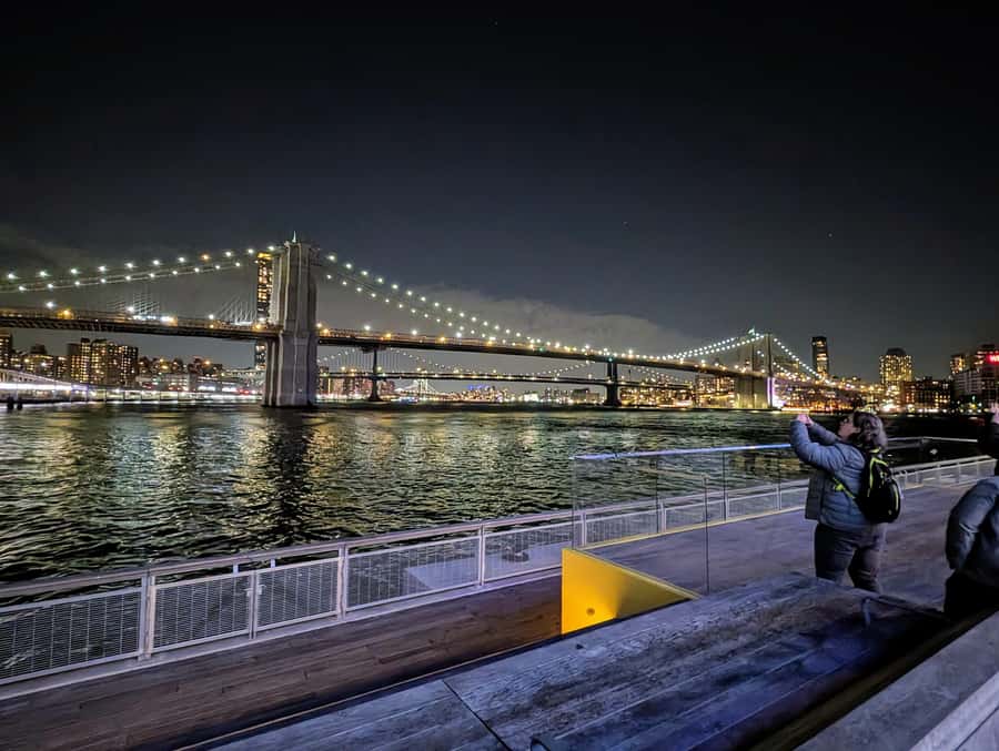 New York City: Guided Private Glass-Top Bus Tour at Night - Pier 17 and the Brooklyn Bridge after sunset