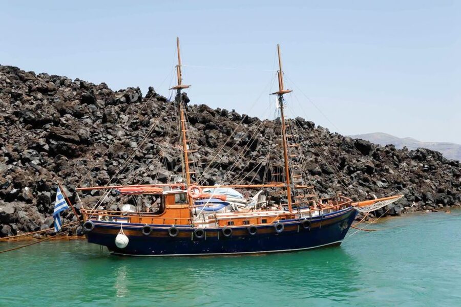 Santorini Island Bus Tour and Caldera Sunset Cruise - Boarding at Athinios and heading toward Nea Kameni